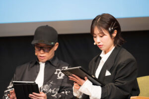 会場の参加者とともに、「TOON8」第1弾『報復の暗殺人形（アサシンドール）』を視聴する、降幡愛さん（右）とずまさん